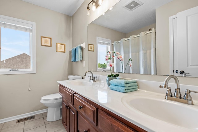 bathroom with visible vents, a sink, and tile patterned floors