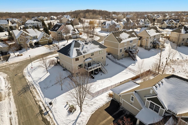 snowy aerial view featuring a residential view