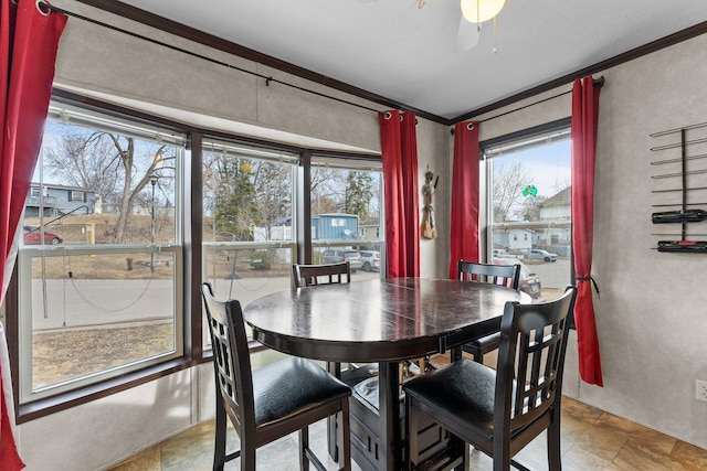 dining space with crown molding and stone finish floor