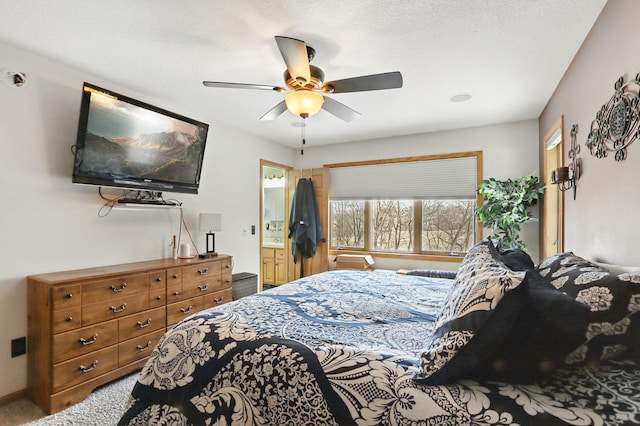 carpeted bedroom featuring ensuite bath and ceiling fan