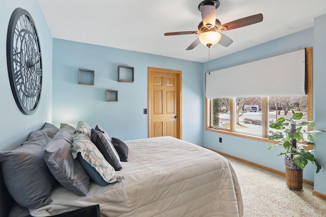 bedroom featuring a ceiling fan, carpet, and baseboards