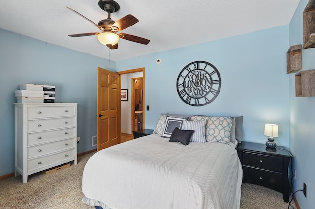 carpeted bedroom featuring visible vents, a ceiling fan, and baseboards