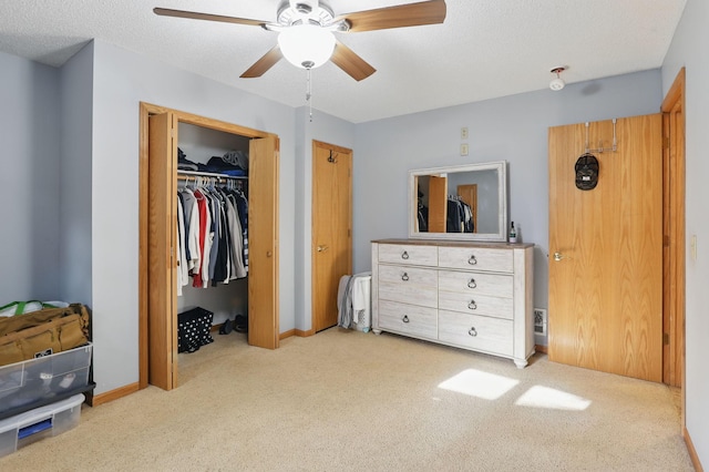 bedroom with baseboards, carpet floors, a textured ceiling, and a ceiling fan