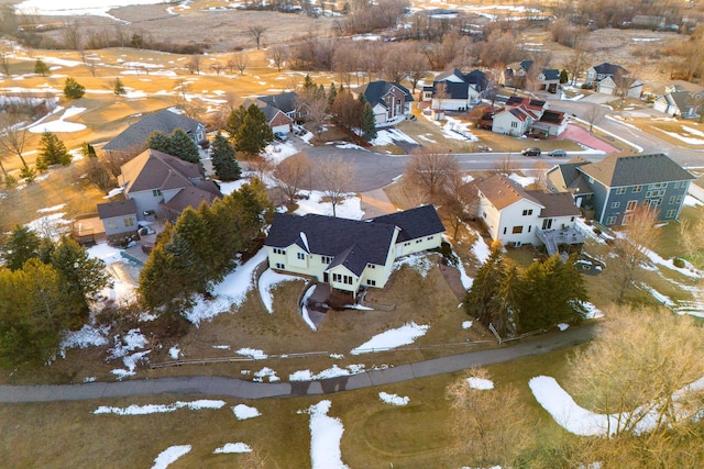 snowy aerial view with a residential view