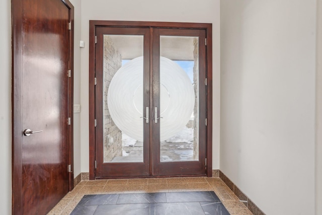 doorway featuring baseboards and french doors