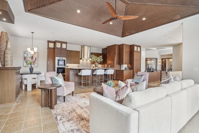 living area with recessed lighting, wood ceiling, a raised ceiling, and ceiling fan with notable chandelier