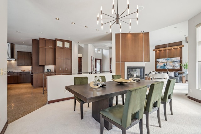 dining area with recessed lighting, light colored carpet, and a fireplace