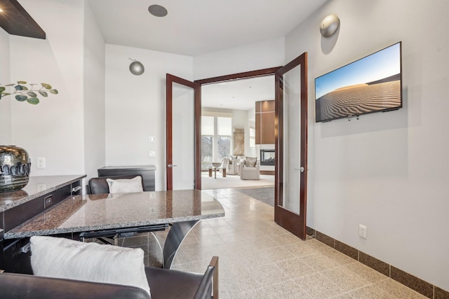 dining area featuring french doors and baseboards