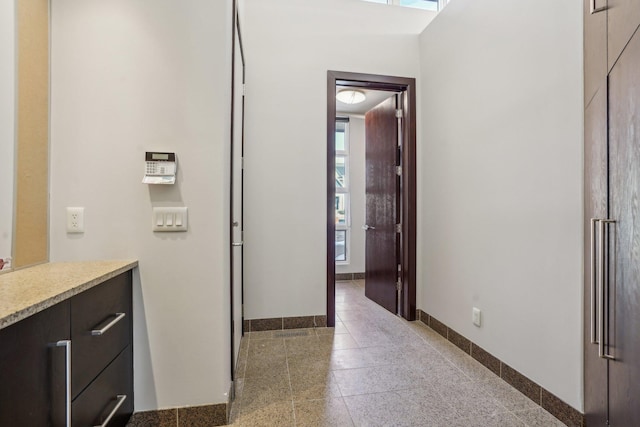 bathroom with granite finish floor and baseboards