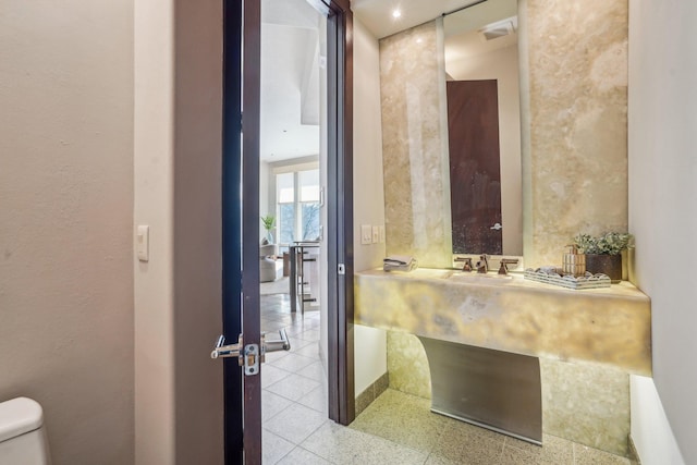 bathroom with toilet and visible vents