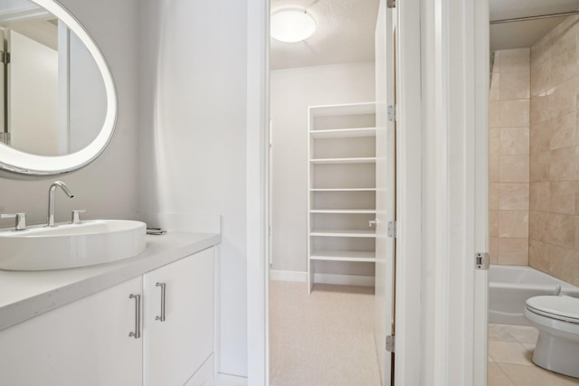 bathroom featuring toilet, tile patterned flooring, and vanity