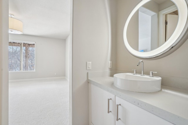 bathroom with vanity and baseboards