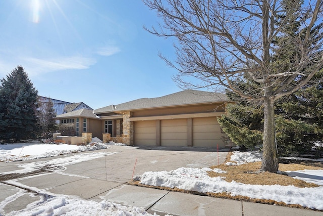 view of front facade featuring stone siding, concrete driveway, and an attached garage