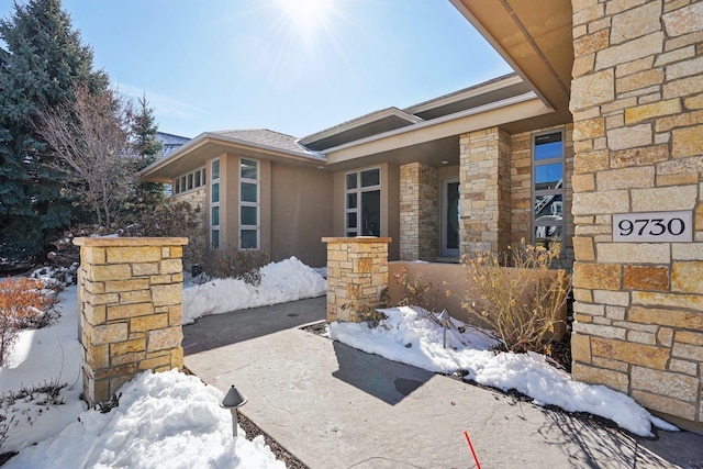 exterior space with stone siding and stucco siding