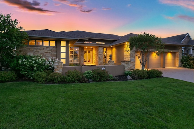 9730 Sky Ln, Eden Prairie, MN 55347 - prairie-style house with stone siding, an attached garage, a front lawn, and concrete driveway