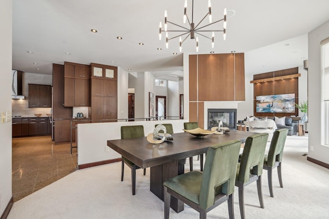 9730 Sky Ln, Eden Prairie, MN 55347 - dining room with a chandelier, recessed lighting, a glass covered fireplace, and light carpet