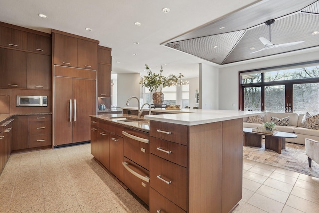 9730 Sky Ln, Eden Prairie, MN 55347 - kitchen with paneled refrigerator, a sink, open floor plan, stainless steel microwave, and modern cabinets