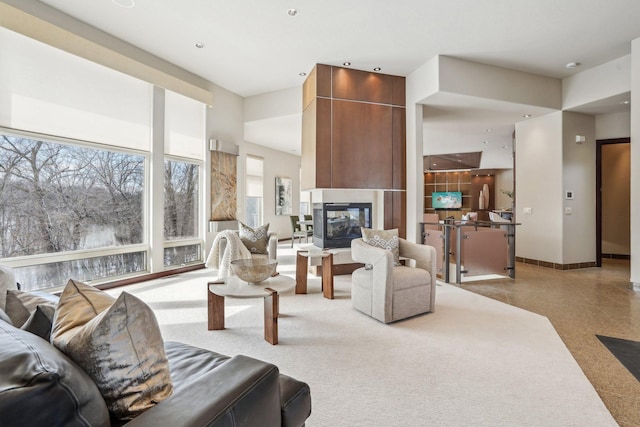 9730 Sky Ln, Eden Prairie, MN 55347 - living room featuring a multi sided fireplace, healthy amount of natural light, and baseboards