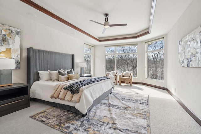 9730 Sky Ln, Eden Prairie, MN 55347 - bedroom with carpet floors, a tray ceiling, ceiling fan, and baseboards