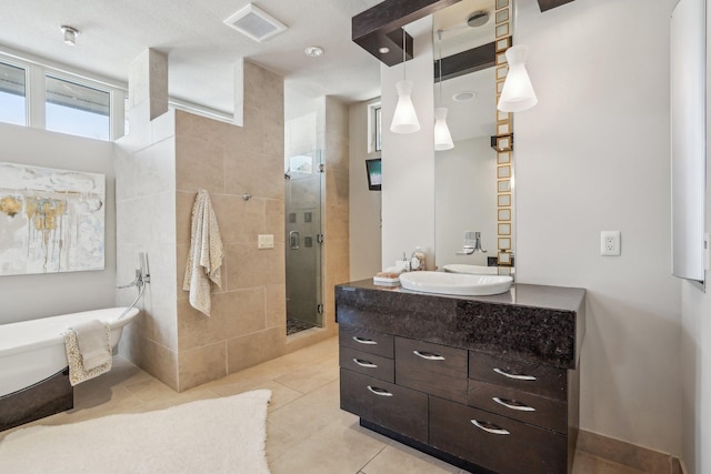 9730 Sky Ln, Eden Prairie, MN 55347 - full bathroom with a stall shower, vanity, a freestanding tub, and tile patterned floors