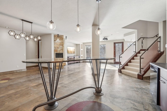 9730 Sky Ln, Eden Prairie, MN 55347 - kitchen with a fireplace, pendant lighting, a textured ceiling, baseboards, and open floor plan