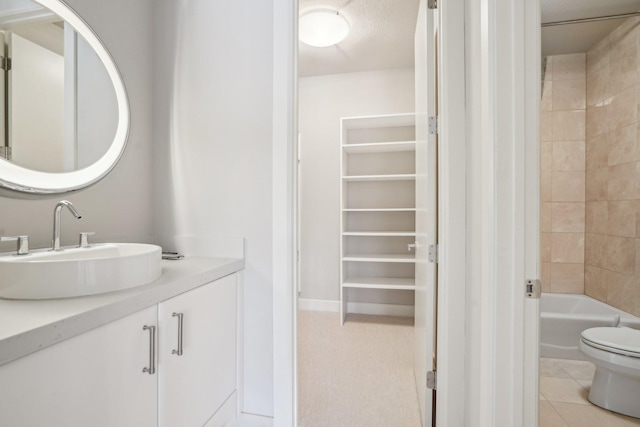 9730 Sky Ln, Eden Prairie, MN 55347 - bathroom featuring toilet, vanity, washtub / shower combination, and tile patterned floors