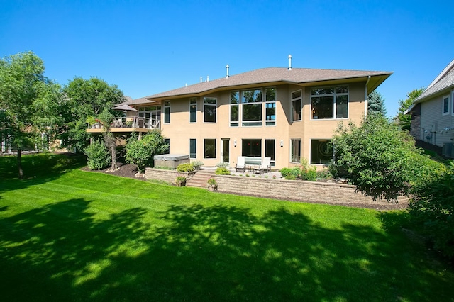 9730 Sky Ln, Eden Prairie, MN 55347 - back of property with stucco siding, a lawn, and cooling unit
