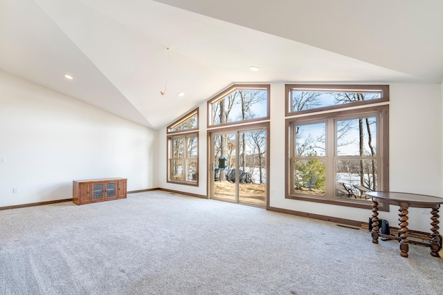 unfurnished living room with recessed lighting, baseboards, carpet floors, and high vaulted ceiling