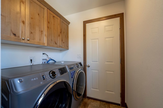 laundry room featuring separate washer and dryer, dark wood-style floors, and cabinet space