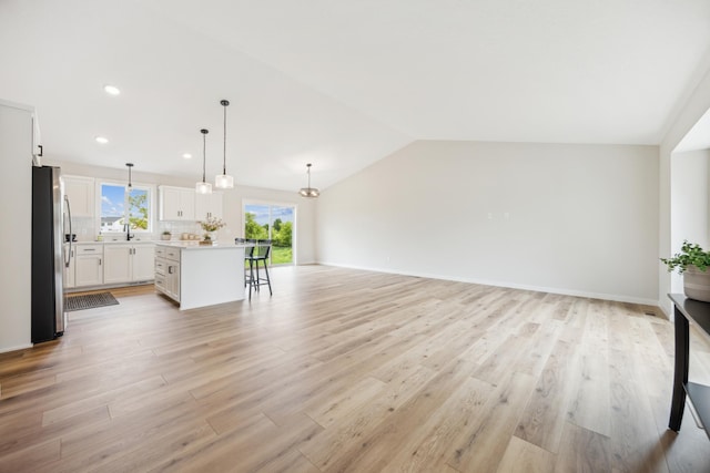 4695 3rd Street Loop NE, Saint Cloud, MN 56304 - unfurnished living room with a sink, light wood-style flooring, lofted ceiling, and recessed lighting
