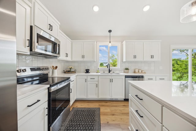 4695 3rd Street Loop NE, Saint Cloud, MN 56304 - kitchen featuring appliances with stainless steel finishes, a sink, light wood finished floors, light countertops, and recessed lighting