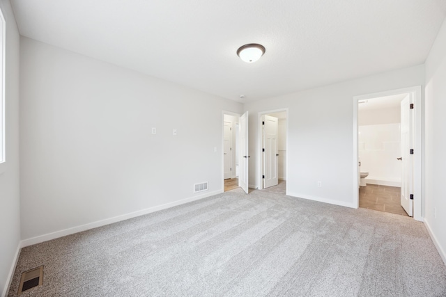 4695 3rd Street Loop NE, Saint Cloud, MN 56304 - unfurnished bedroom with carpet floors, baseboards, a spacious closet, and ensuite bathroom
