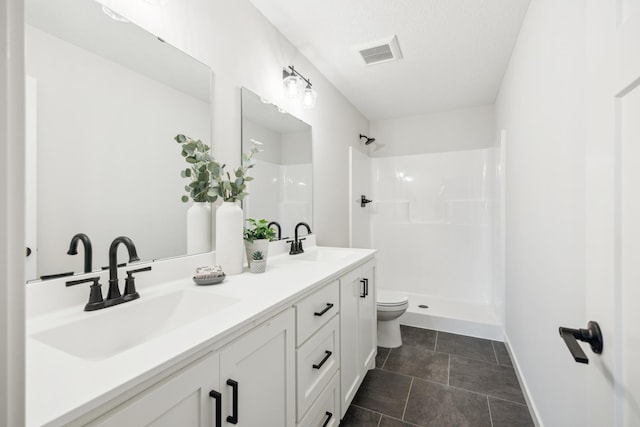 4695 3rd Street Loop NE, Saint Cloud, MN 56304 - bathroom featuring toilet, double vanity, a shower, baseboards, and tile patterned flooring