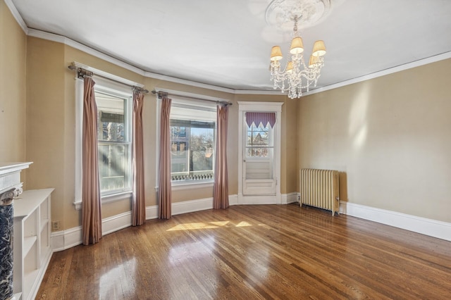 interior space featuring baseboards, radiator, ornamental molding, wood finished floors, and a chandelier