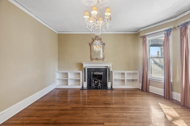 unfurnished living room featuring a notable chandelier, a premium fireplace, ornamental molding, wood finished floors, and baseboards