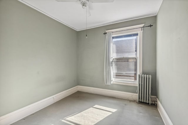 unfurnished room featuring a ceiling fan, baseboards, and radiator heating unit