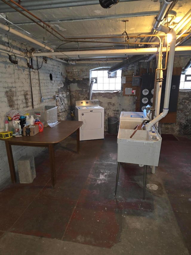 basement featuring washer and clothes dryer and a sink