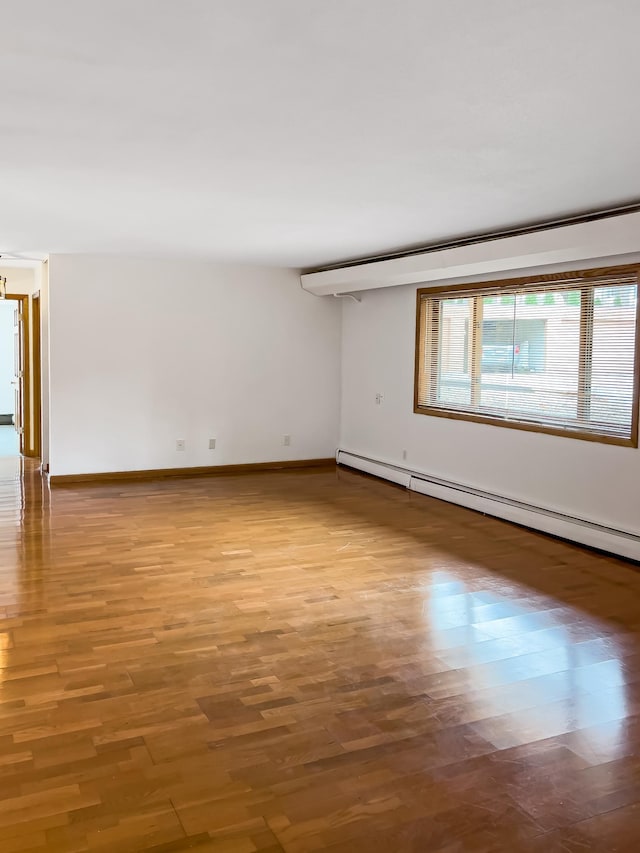 5440 Three Points Blvd Unit 513, Mound, MN 55364 - spare room with a baseboard heating unit, wood finished floors, and baseboards