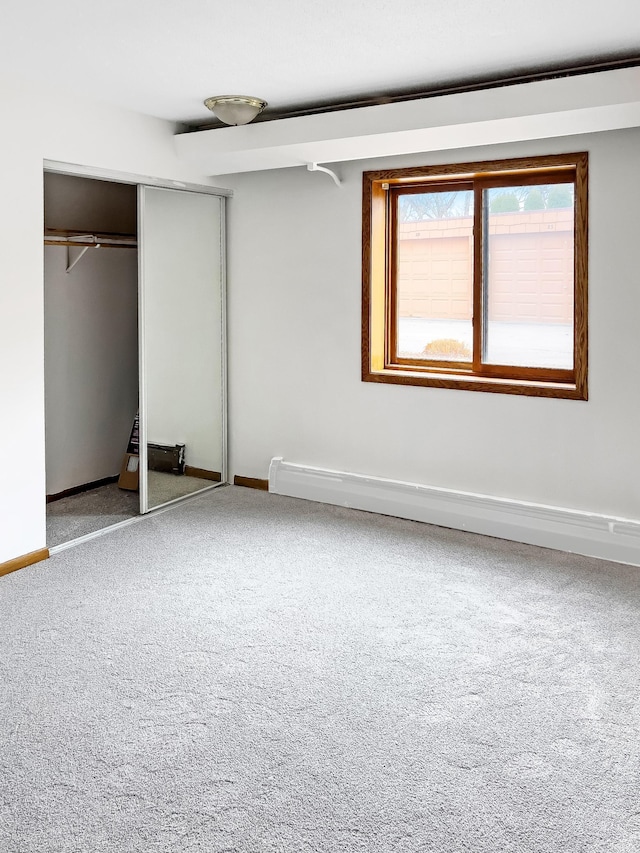5440 Three Points Blvd Unit 513, Mound, MN 55364 - unfurnished bedroom featuring carpet flooring, baseboards, and a closet