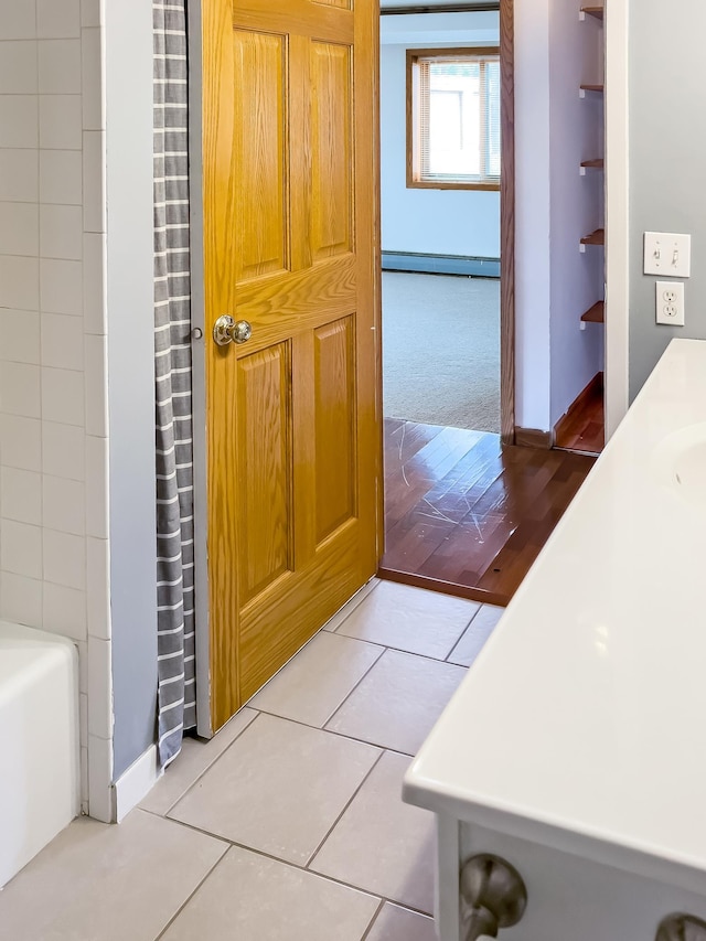 5440 Three Points Blvd Unit 513, Mound, MN 55364 - full bath featuring a baseboard radiator, baseboards, vanity, and tile patterned floors