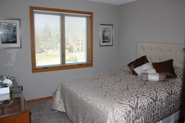 bedroom featuring carpet floors and baseboards