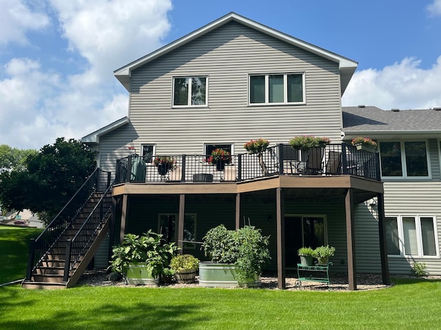 rear view of house with stairs, a deck, and a yard