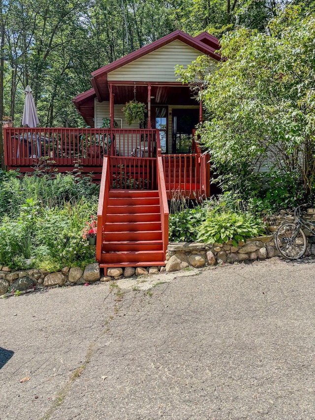 view of front of home with covered porch and stairs