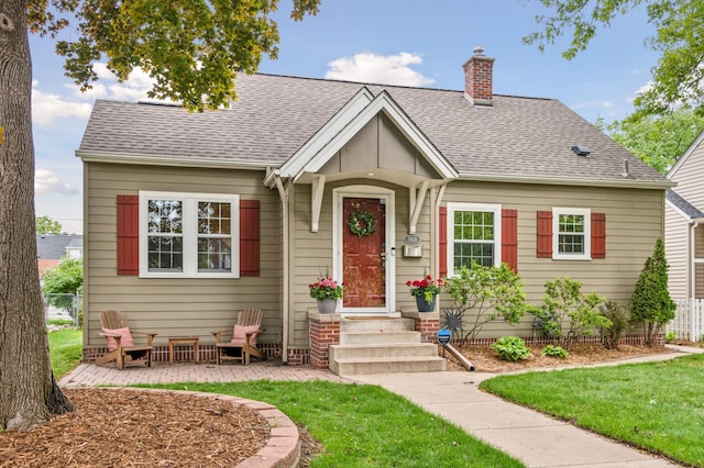 5824 10th Ave S, Minneapolis, MN 55417 - view of front of house with a chimney and a shingled roof