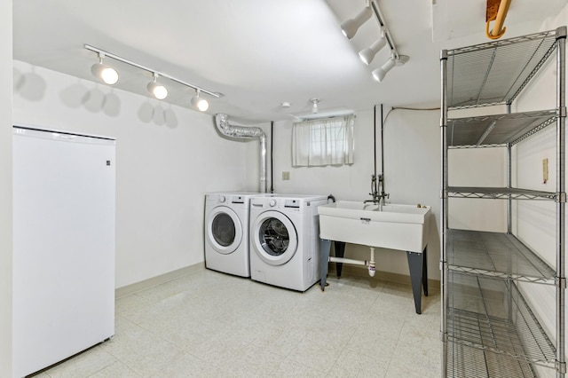 5824 10th Ave S, Minneapolis, MN 55417 - washroom featuring washer and dryer, track lighting, baseboards, and light flooring