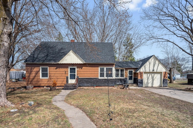 1610 Hennepin Ave N, Glencoe, MN 55336 - view of front of house featuring concrete driveway, an attached garage, stone siding, roof with shingles, and a front yard