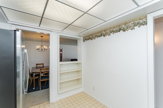 2053 Carriage Dr SW Unit 2053E, Rochester, MN 55902 - empty room with a chandelier, baseboards, and light floors