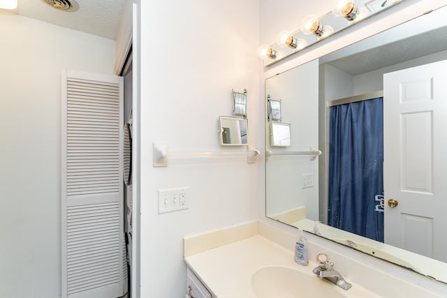2053 Carriage Dr SW Unit 2053E, Rochester, MN 55902 - bathroom featuring vanity and a textured ceiling