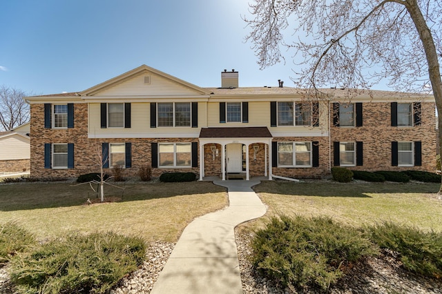 2053 Carriage Dr SW Unit 2053E, Rochester, MN 55902 - multi unit property featuring a chimney, a front yard, and brick siding