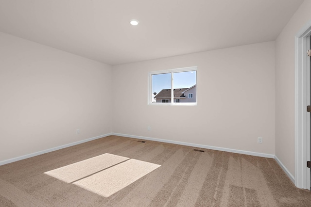 spare room with recessed lighting, visible vents, carpet flooring, and baseboards